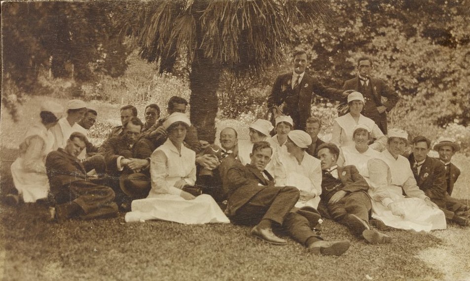 a large group of people in vintage dress posing for a picture