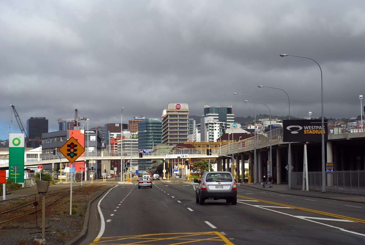 a city street with traffic and buildings in the distance