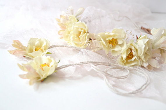 flower heads tied to a lace and tied to a ribbon