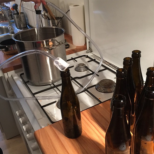 a stove top oven with bottles sitting on the counter