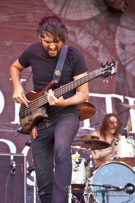 a man playing the bass guitar on stage