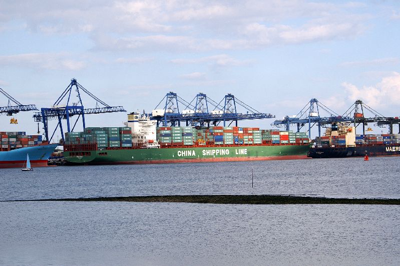 an ocean port with large cargo containers being loaded