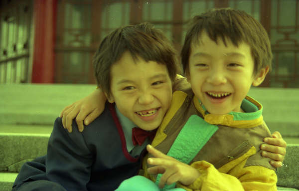 two children sitting on the steps smiling