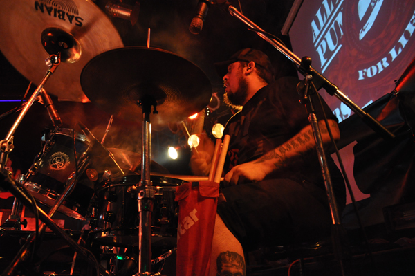 a man sitting at a drums set playing