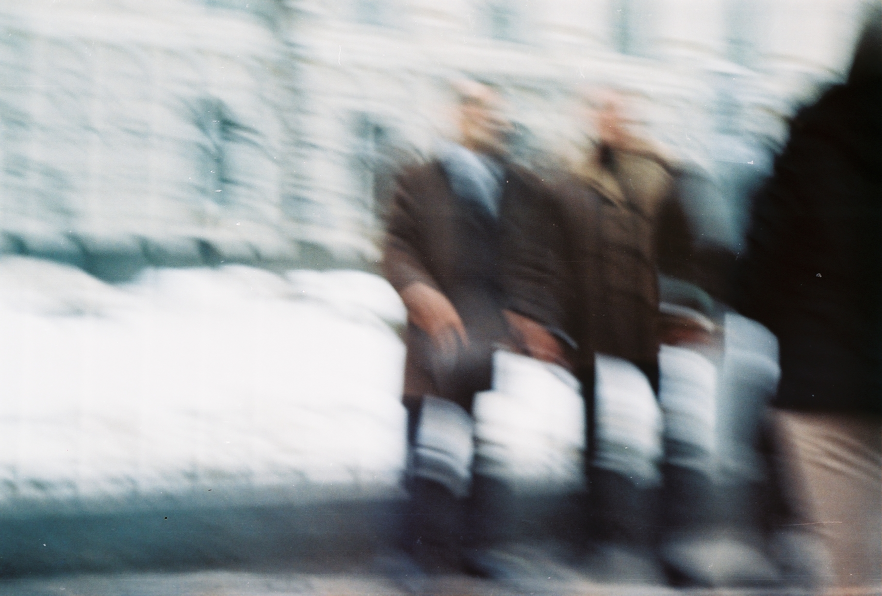 a blurry po of several people standing in the snow