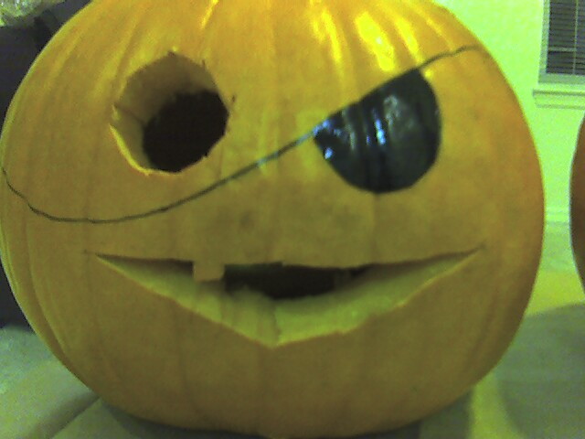 a pumpkin carving with a big black nose