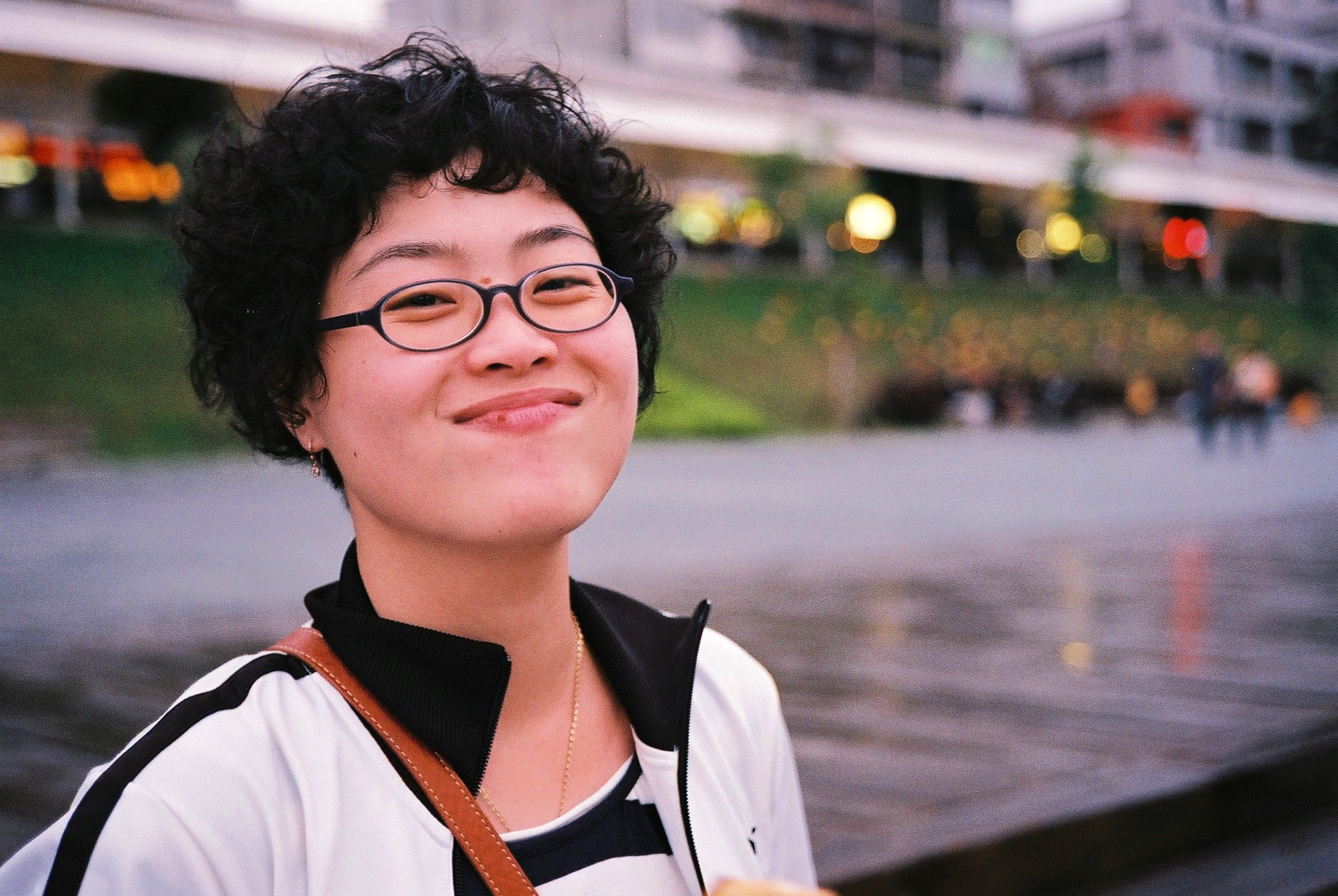 a woman wearing glasses and a striped shirt