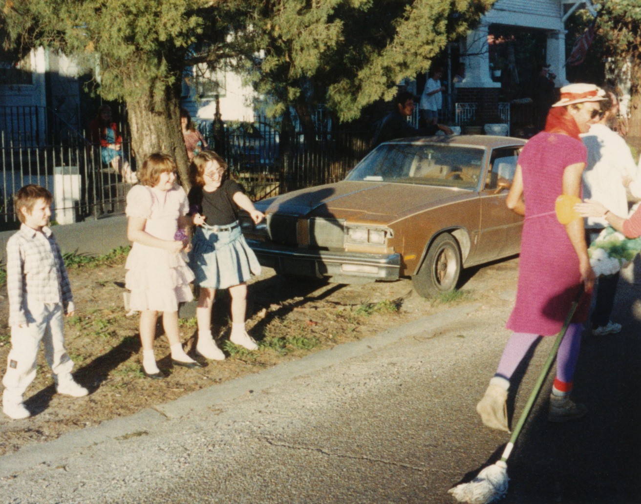 a group of young people standing on the side of a road