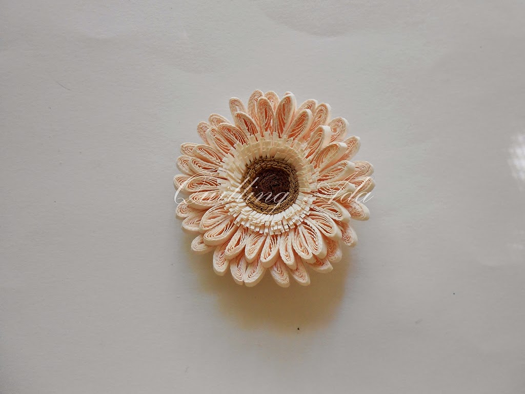 a pink flower is held in place on a white surface