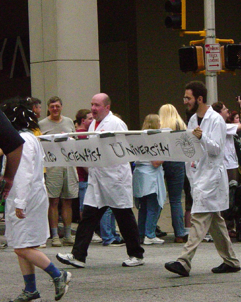 there are some people walking down the street holding signs