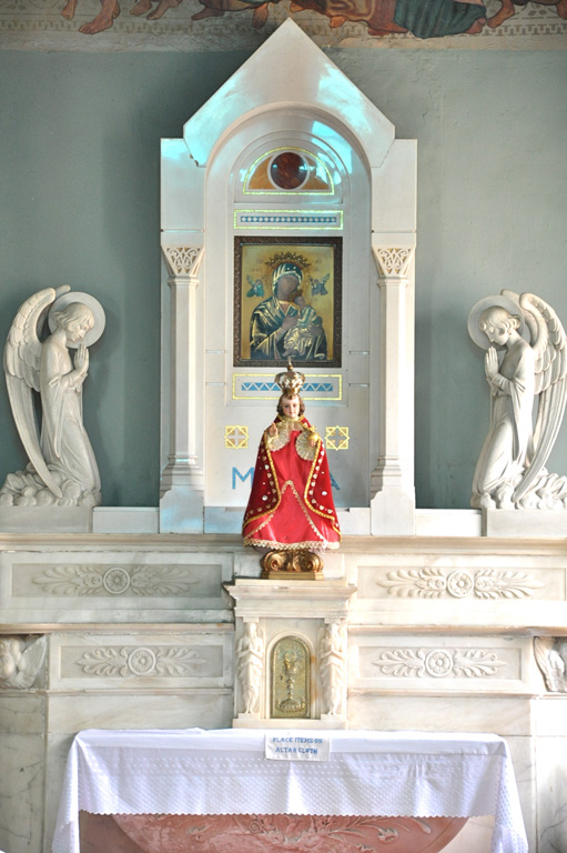 an ornate alter with religious pictures in the background