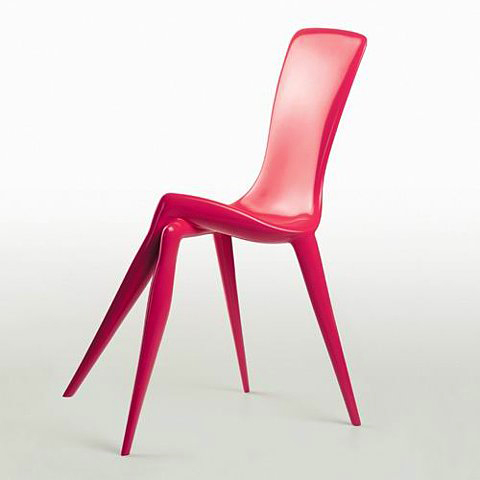 a plastic chair with bent legs in pink