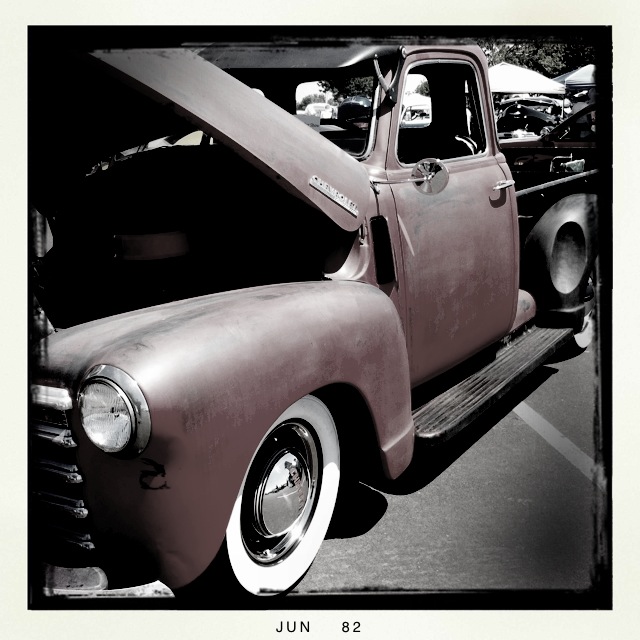 old truck parked at a car show