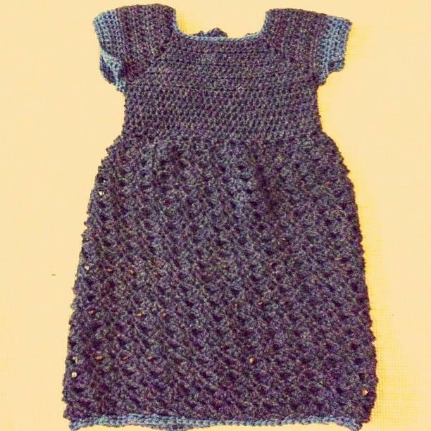 a dress made out of yarn that has blue details