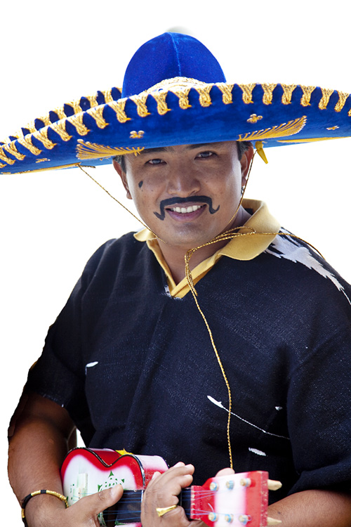 a man dressed in a sombrero smiles while holding two cups