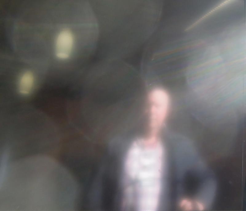 a blurry po shows two people in front of a large sunburst