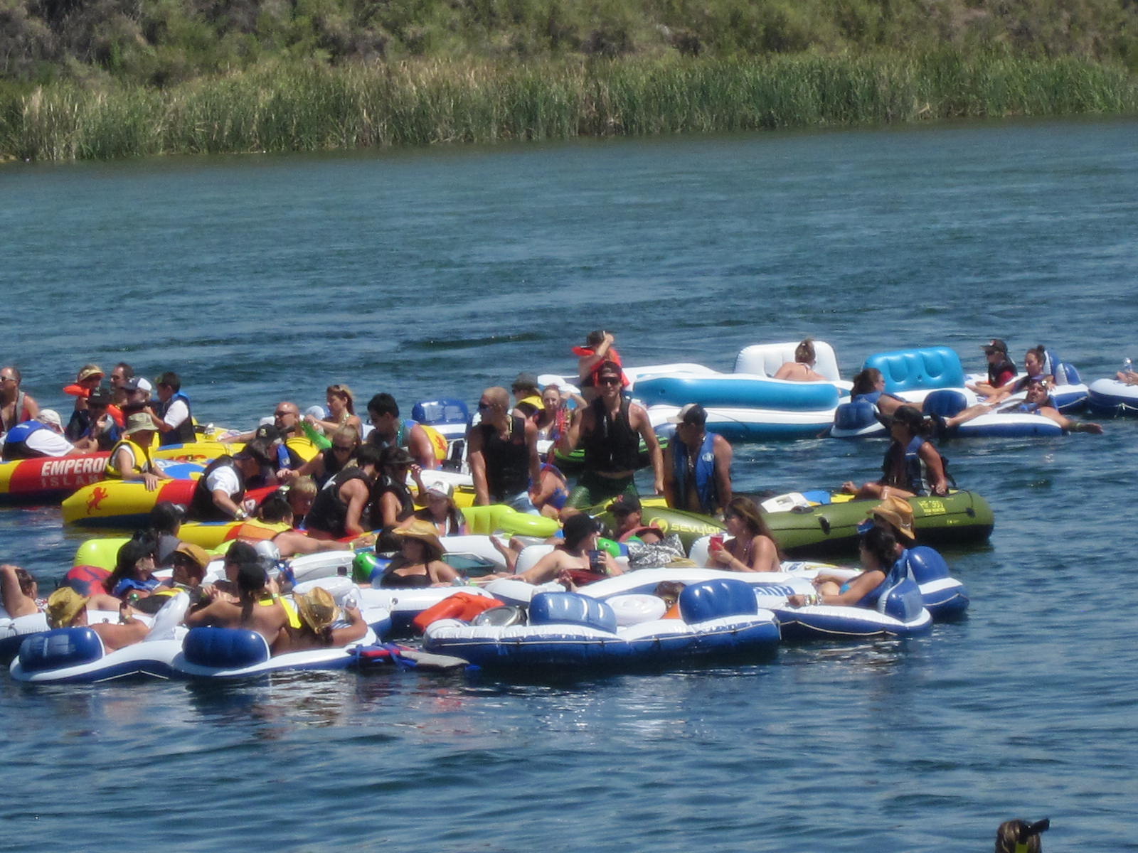 a group of people are floating on rafts in the water