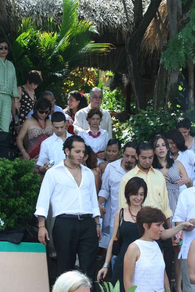 a large crowd of people walking along side each other