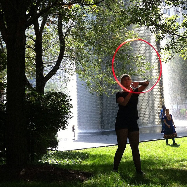woman in the park with hula hoop on her face