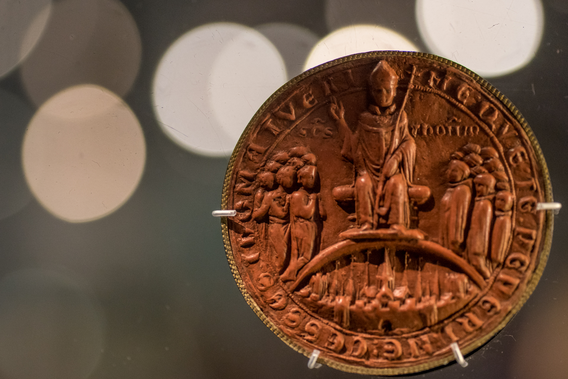 an orange penny with the image of a family on it