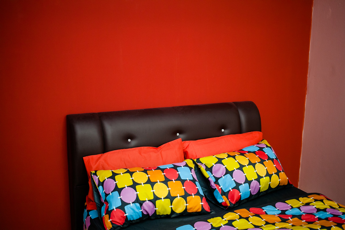 a bed that has a colorful comforter on it