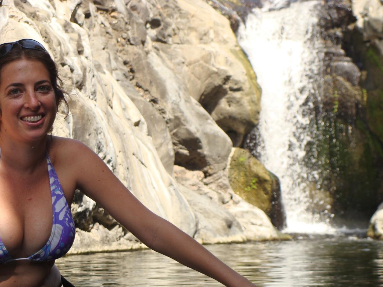 a woman wearing blue bikini on top of rocks