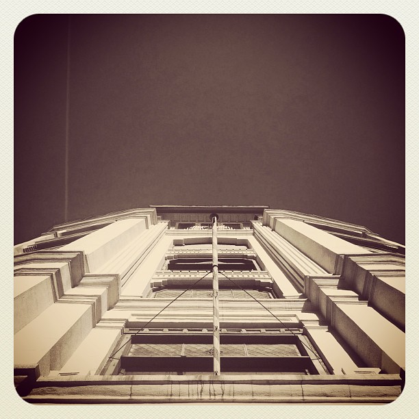 the top of an architectural building with vertical balconies