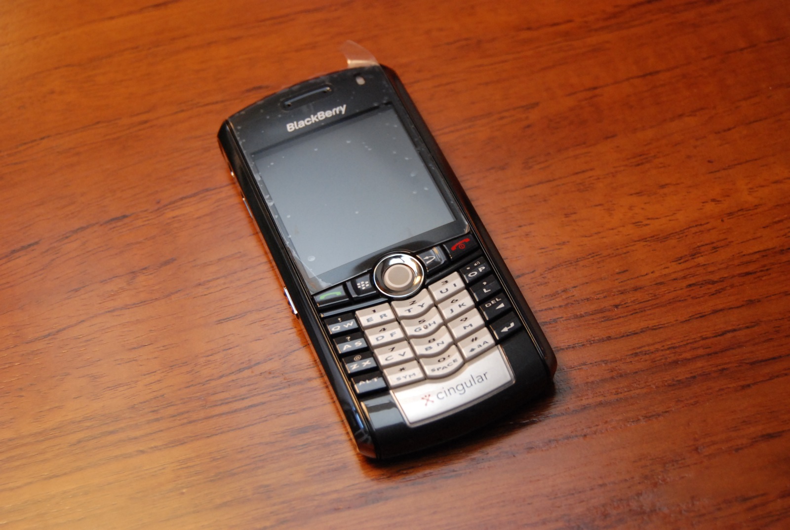 an old cell phone sitting on a wooden table