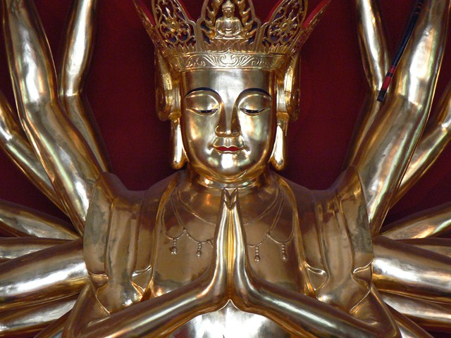 a gold statue with a crown on top