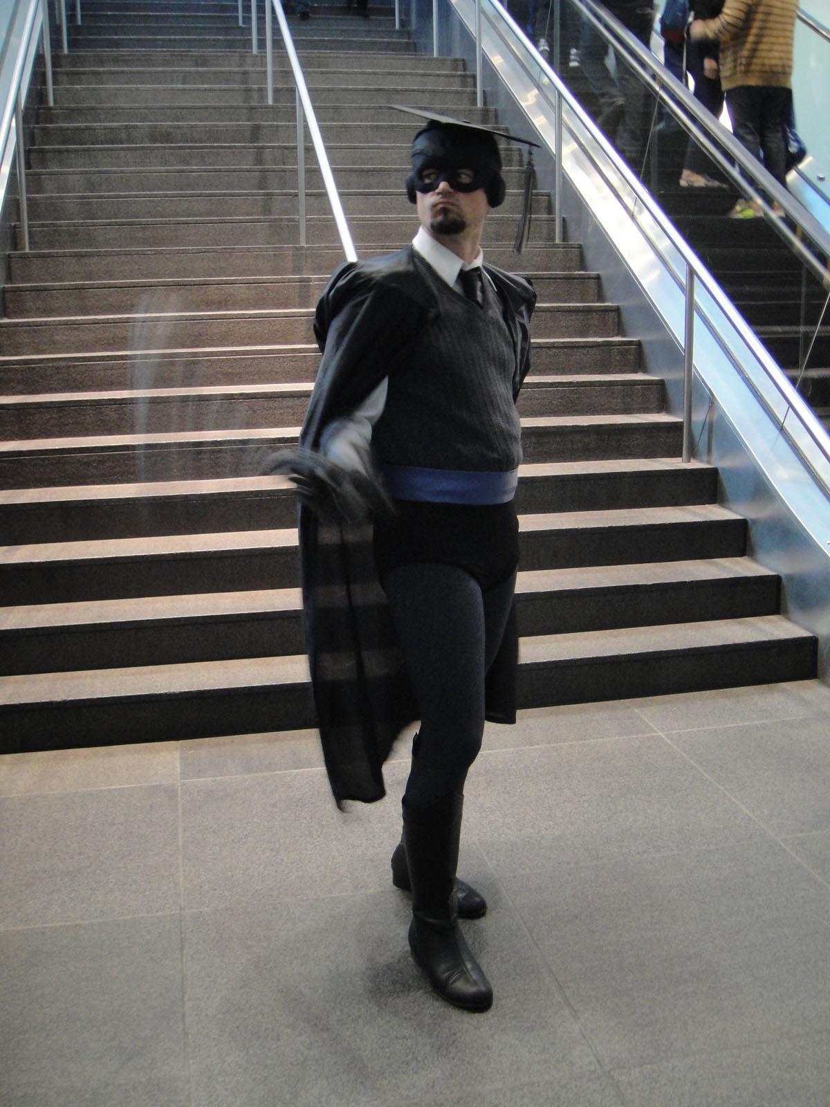 a man wearing a costume standing in front of some stairs