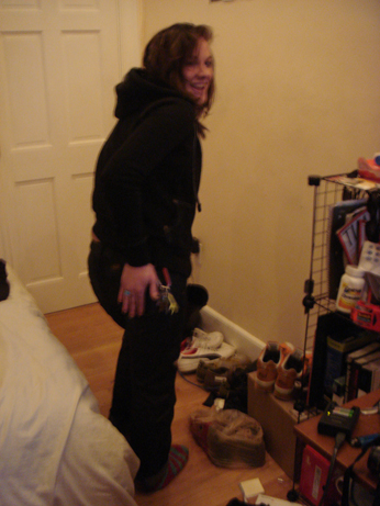 woman in black jacket and boots standing on wooden floor