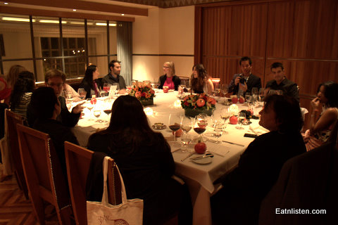 group of people sitting around a table eating dinner