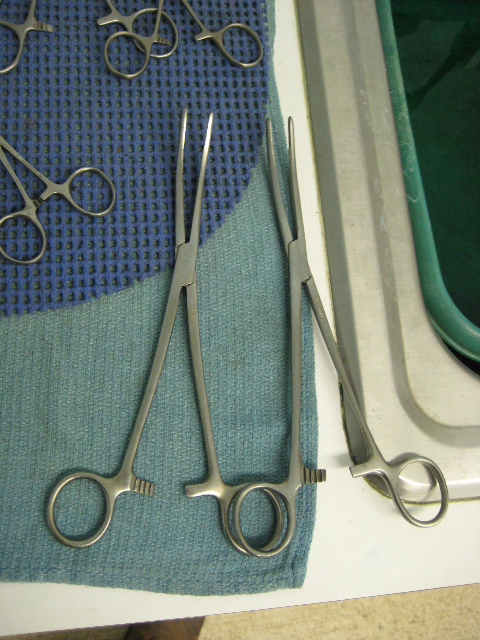 scissors on top of a cloth next to a pair of scissors