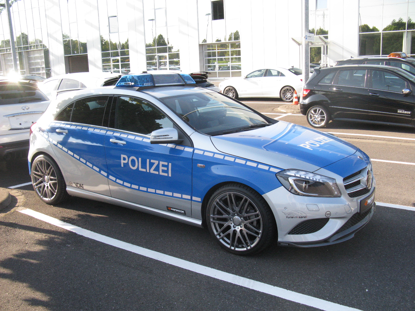 police car driving in front of some other cars