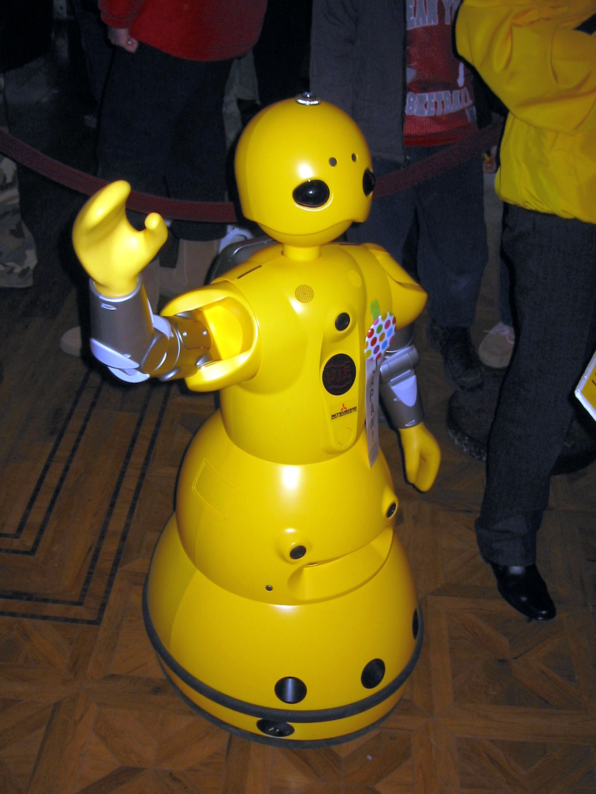 the yellow robot is holding soing in its hand