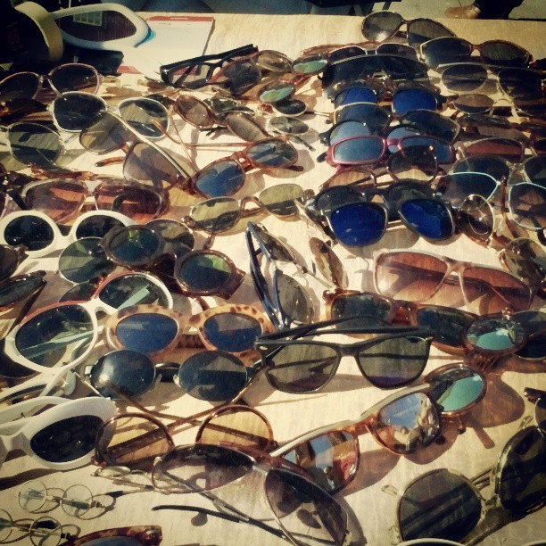 many different kinds of sunglasses are on a table