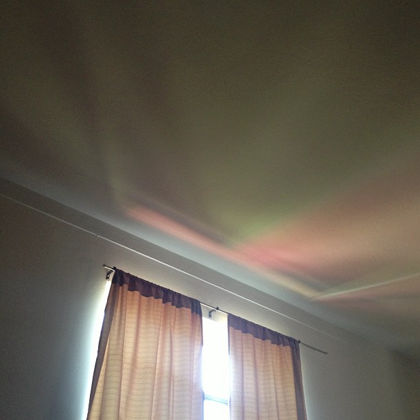 the light coming in through the curtains casts on the wall