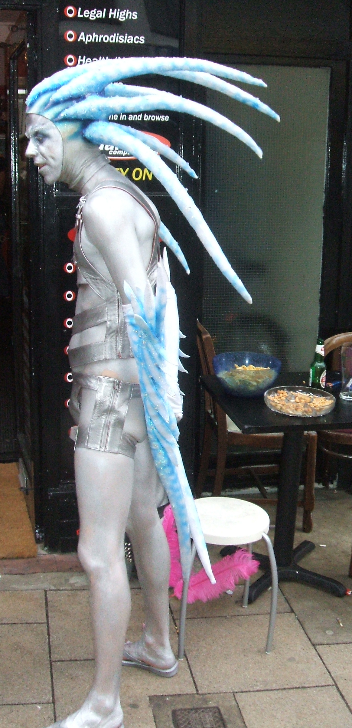 a white costume is in front of a cafe