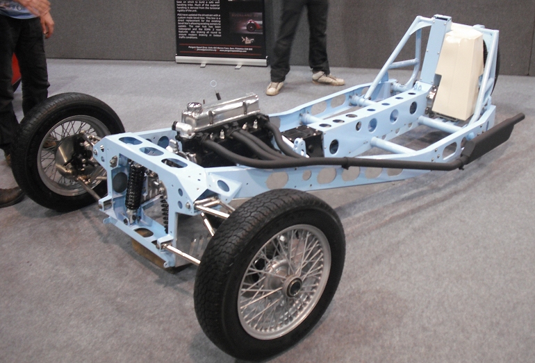 a motor vehicle on display with other people standing around