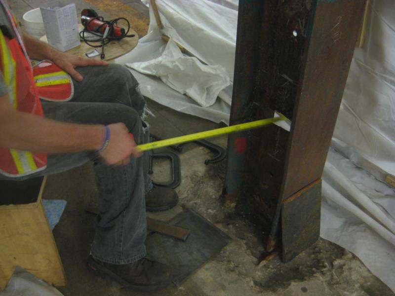 an worker measuring the height of a tall object