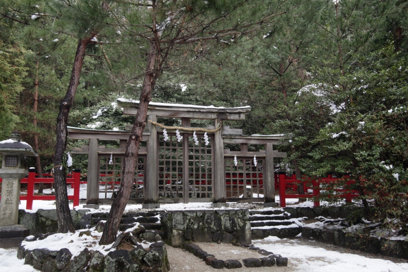 a gate is between some rocks and snow