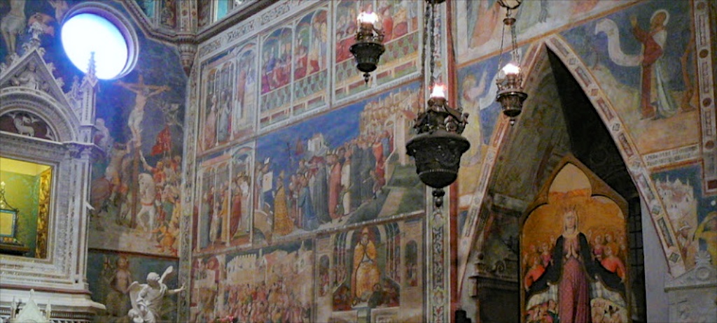 a church with a wall painting that has many pictures on it