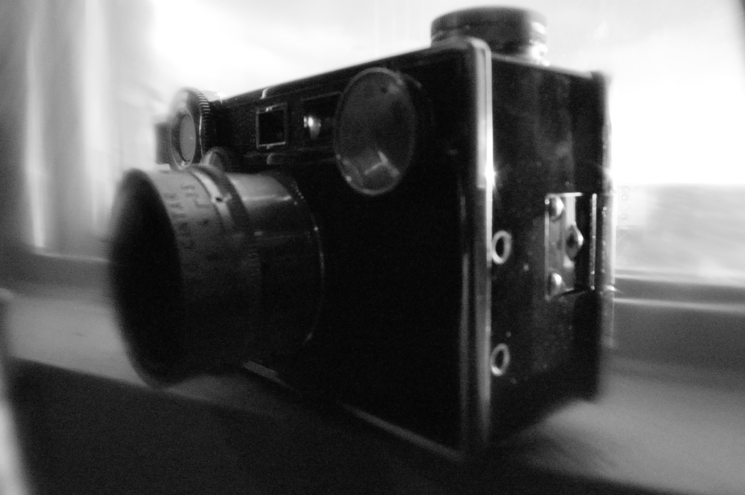 a black and white po of a camera on a window sill