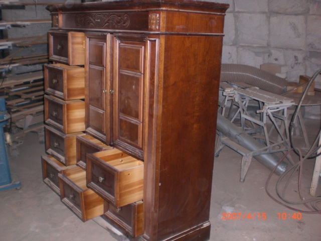 some sort of cabinet with several drawers and shelves