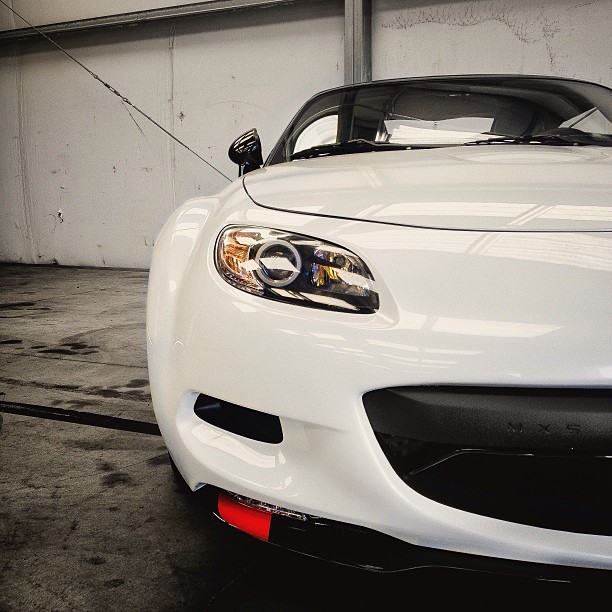 a white sports car parked in a building