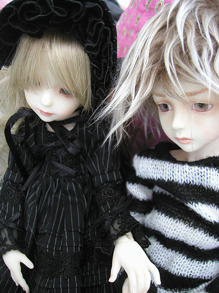 two dolls that are next to each other