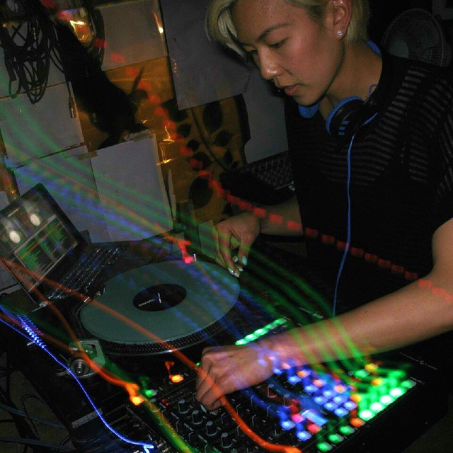 a person that is djing in front of a laptop