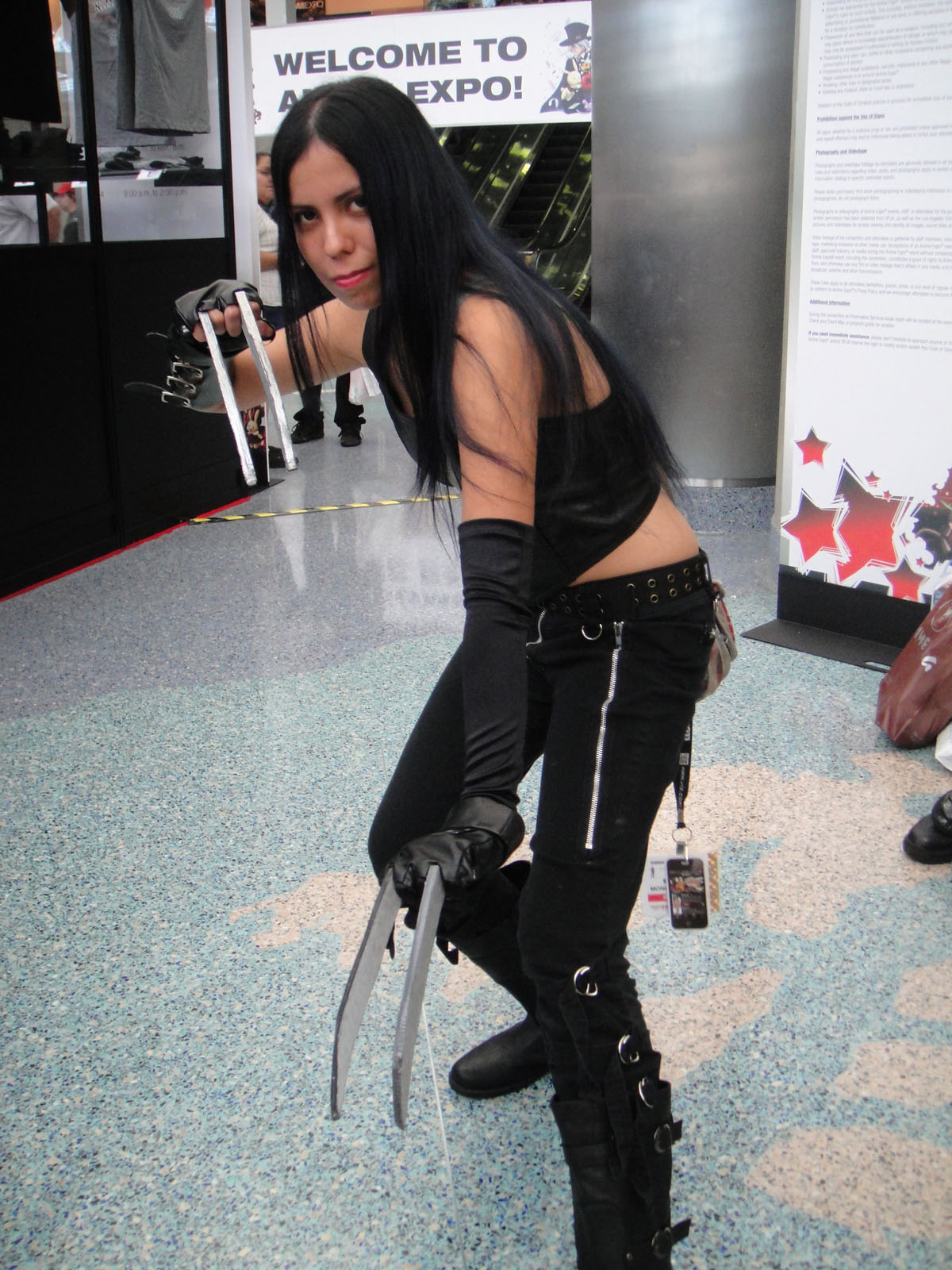 a girl in black outfit holding a pair of scissors