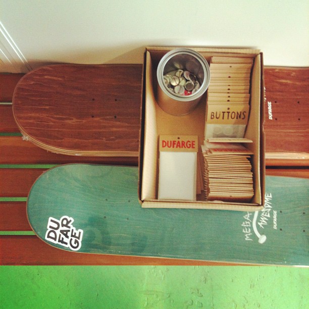 a wooden skateboard and some coins on a table