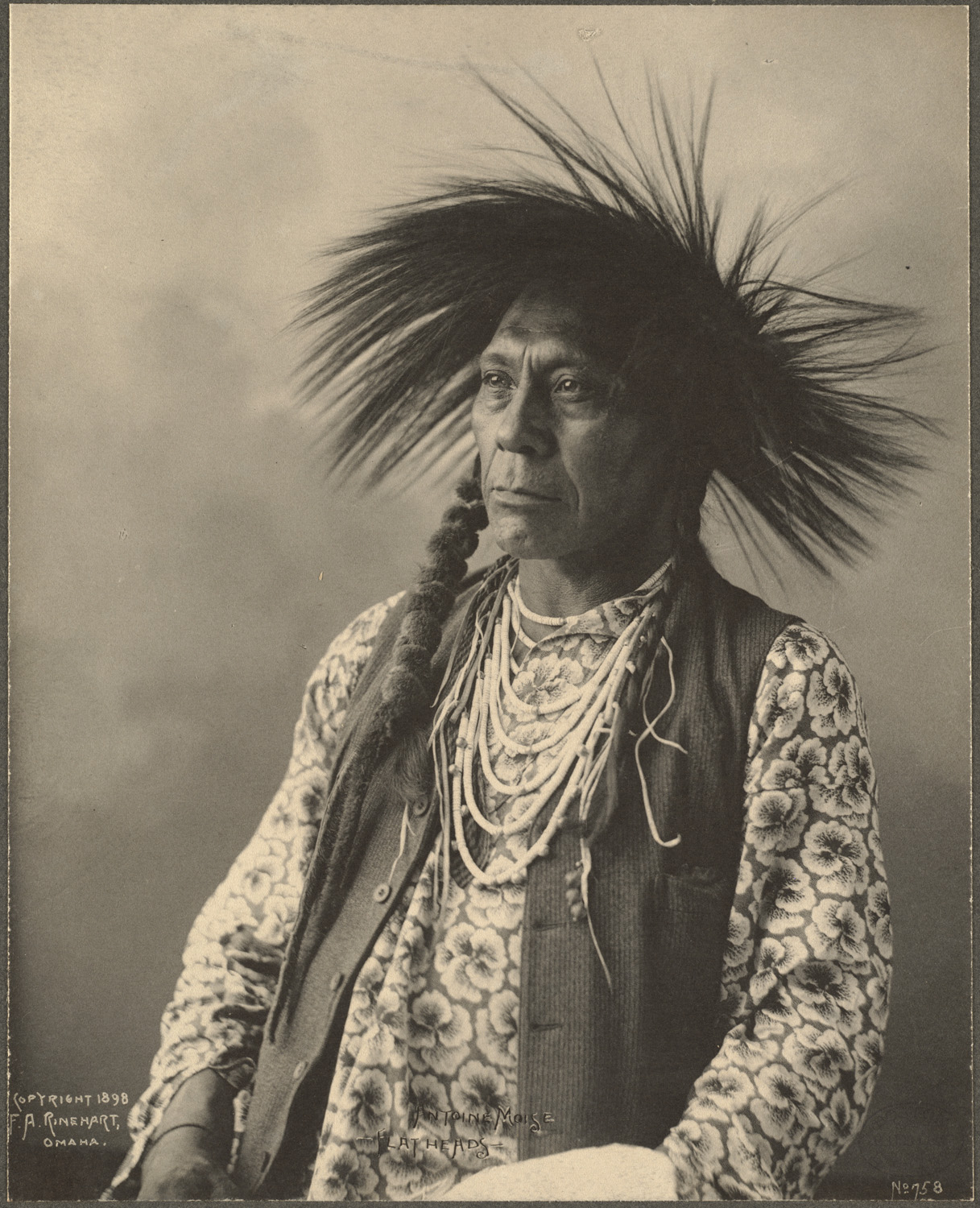 an old po shows an indian woman with a headdress